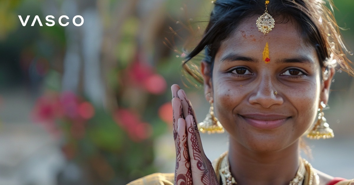 Een vrouw in traditionele Indiase kleding met handen in een groetgebaar, die uitbeelden hoe je hallo zegt in meerdere talen.